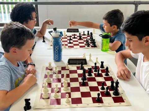 a group of boys playing chess
