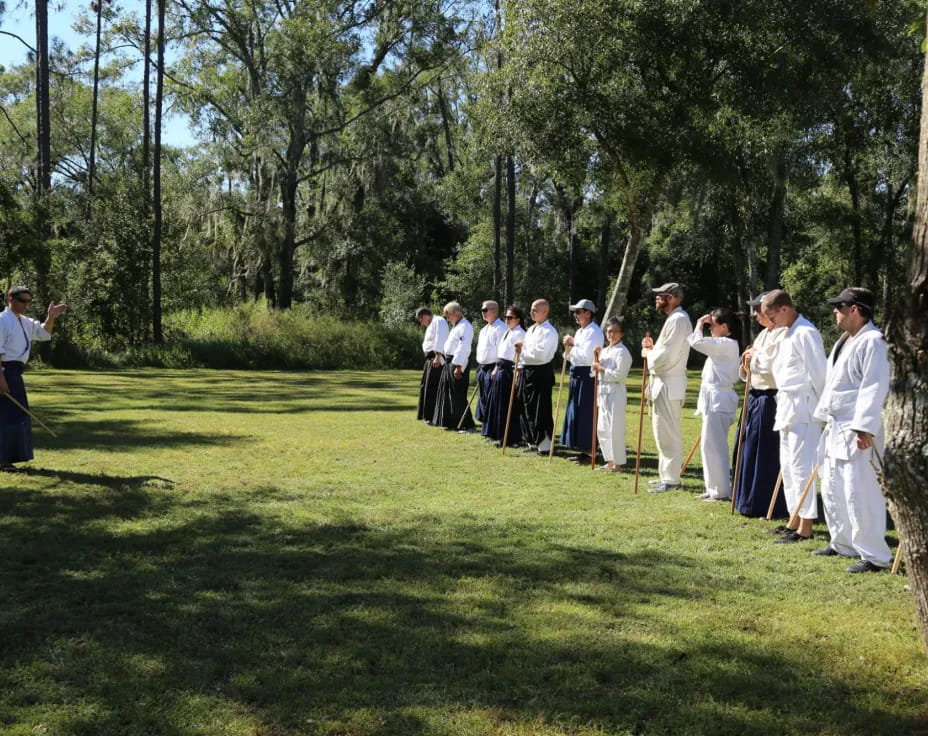 a group of people in white robes standing on a golf course