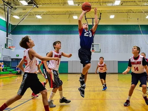 a group of people playing basketball