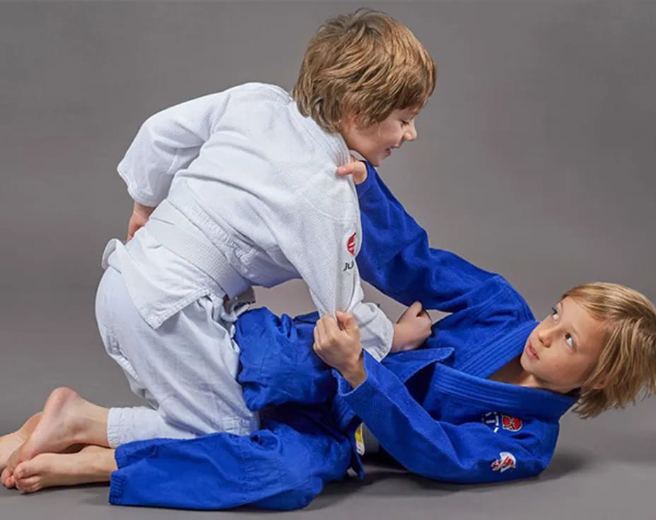 a boy and a girl in karate uniforms