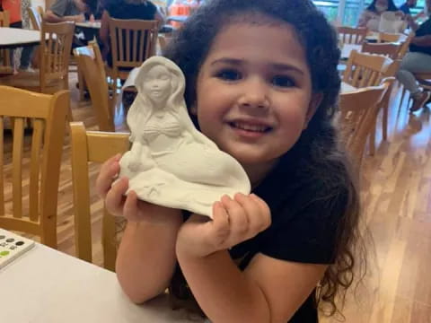 a girl holding an ice cream cone