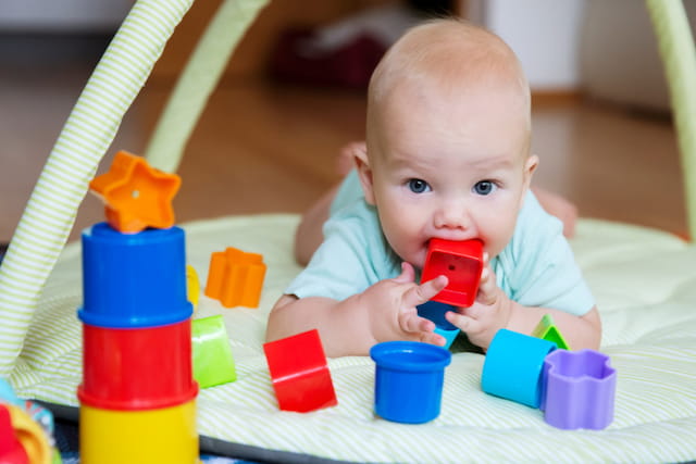 a baby playing with toys