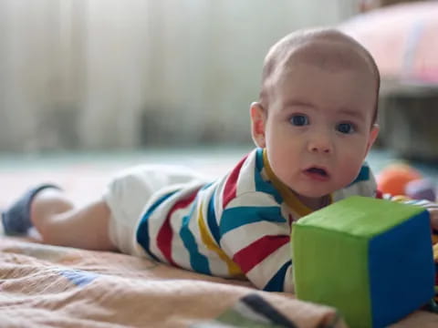 a baby lying on a blanket