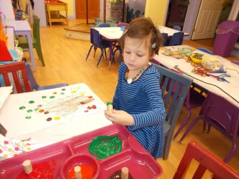 a girl painting on a table