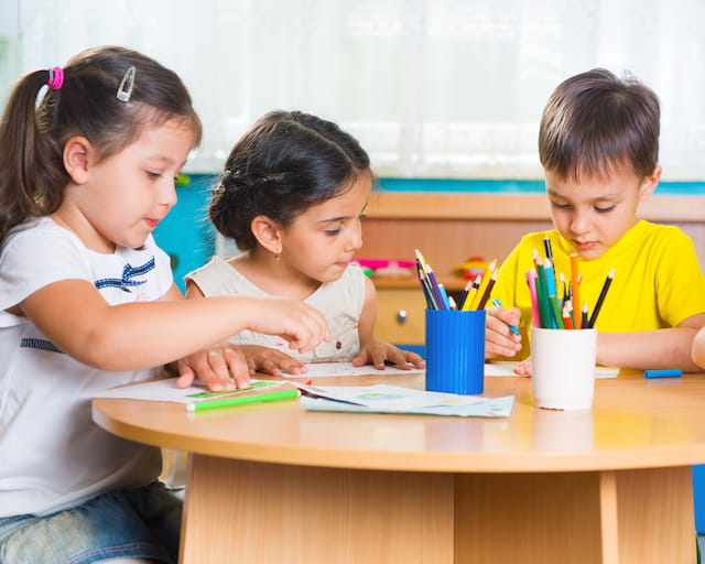 a few children sitting at a table