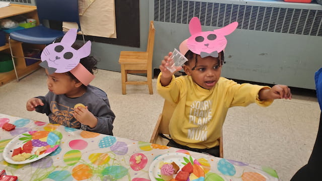 a couple of kids wearing party hats