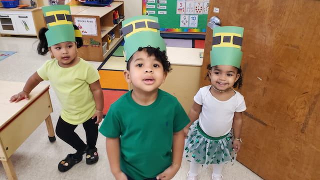 a group of children wearing party hats