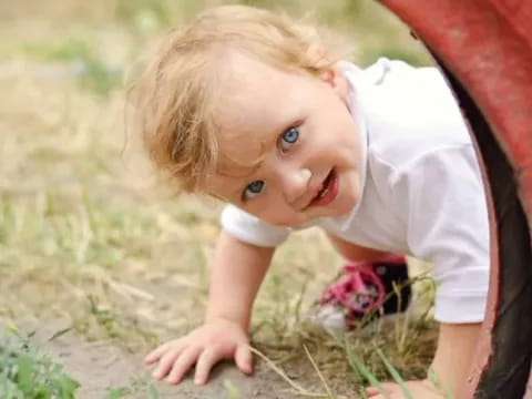 a child playing with a flower