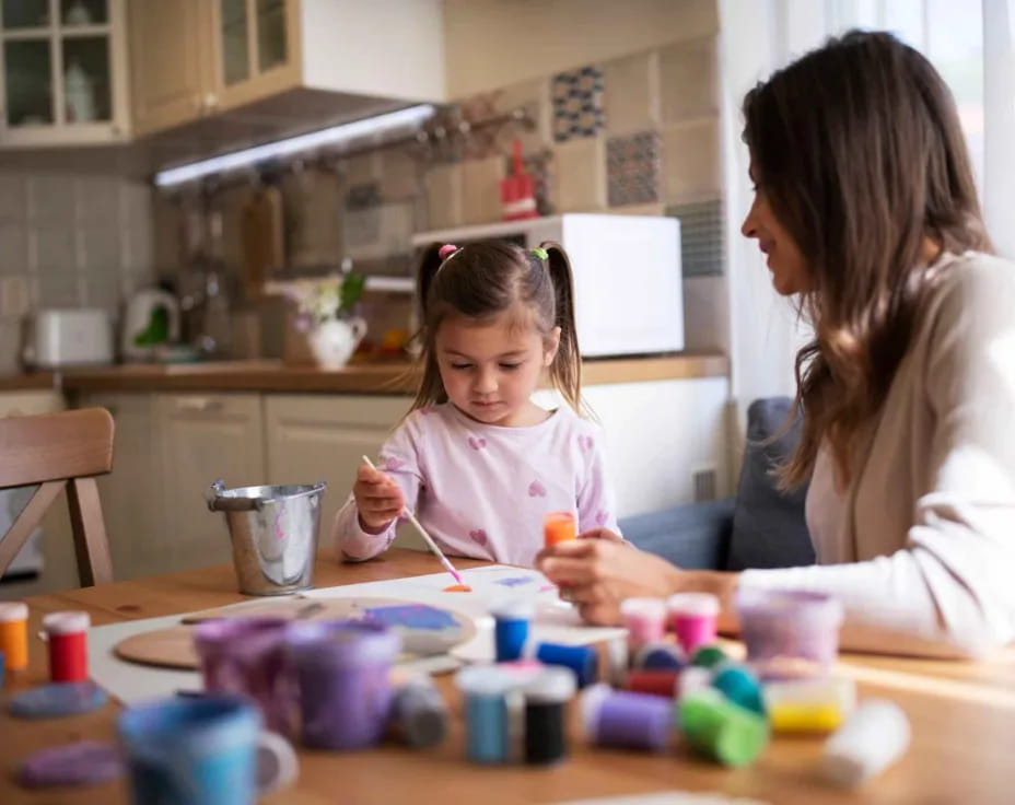 a person and a child painting