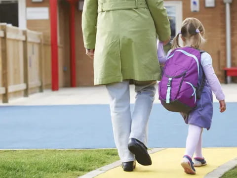 a woman walking with a girl