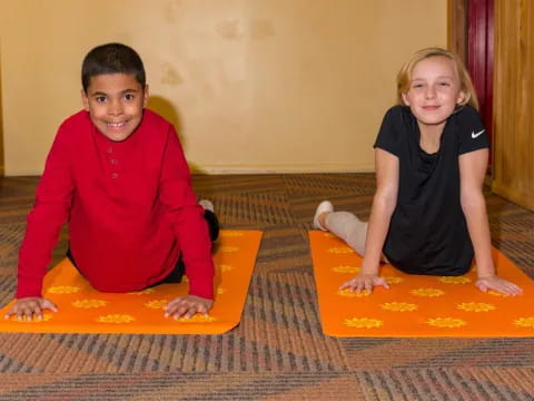 a boy and girl sitting on the floor