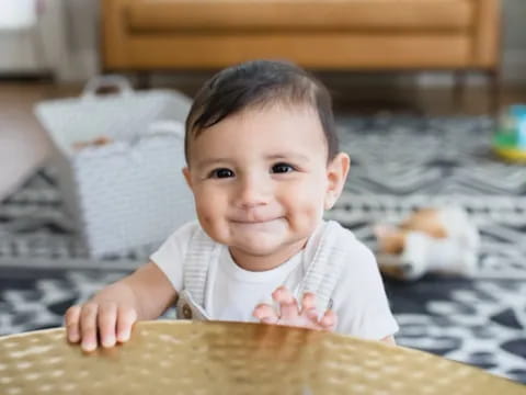 a baby crawling on a rug