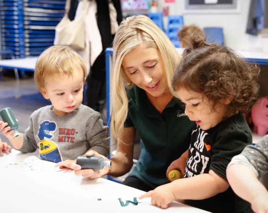 a person and kids sitting at a table