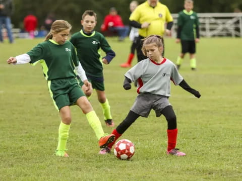 girls playing football on a field
