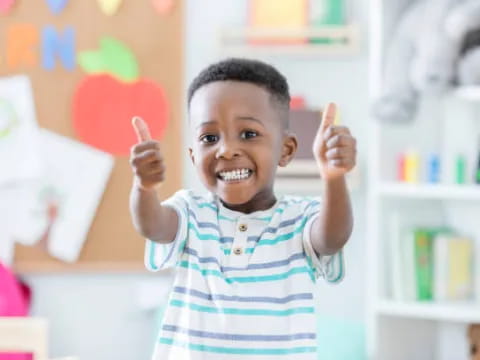 a young boy holding up his fingers