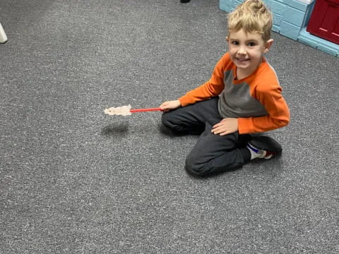 a boy sitting on the floor