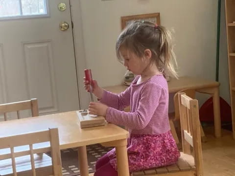 a girl sitting at a table
