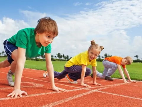 a group of kids playing on a track
