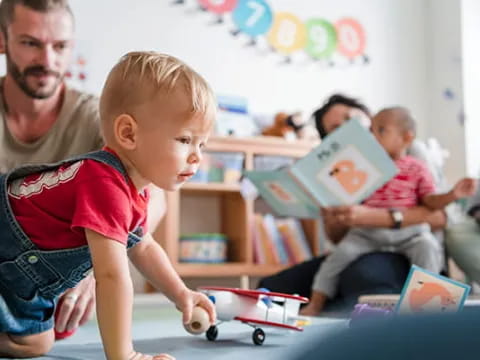 a person reading a book to a child