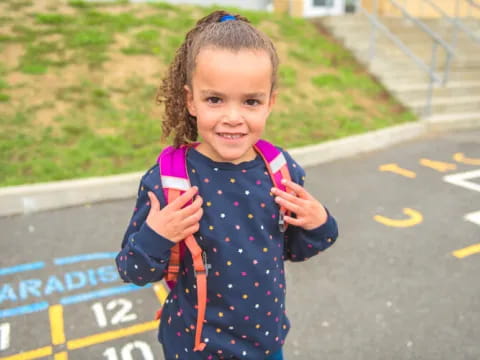 a child holding a medal