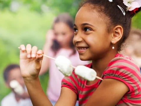 a young girl holding a ball