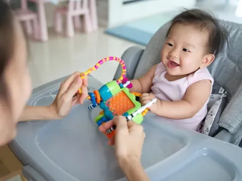 a baby playing with a toy