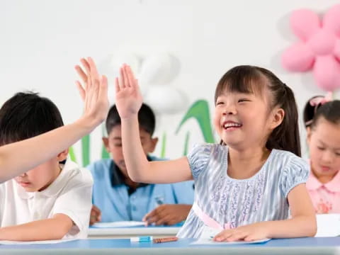 a group of children raising their hands