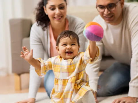 a man and woman holding a baby