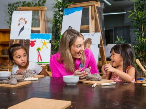 a person and two children painting