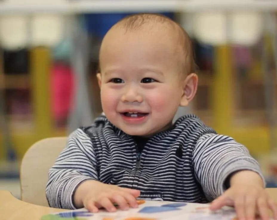 a baby sitting at a table