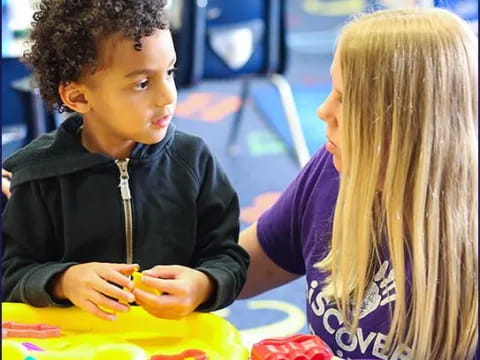 a boy and girl playing with toys