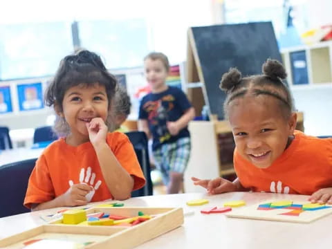 a few children sitting at a table