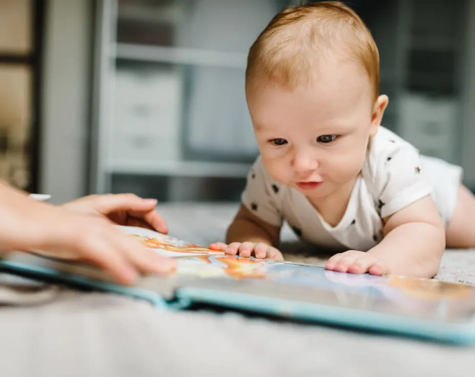 a baby looking at a tablet