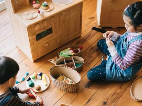 a couple of children sitting on the floor eating from bowls