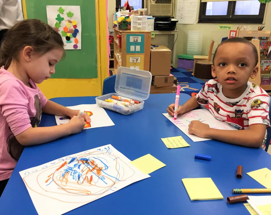 a few children sitting at a table