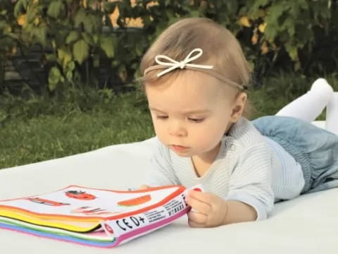 a baby lying on a blanket