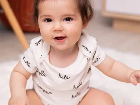 a baby lying on a bed