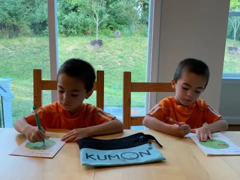 two boys sitting at a table