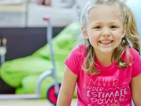 a girl smiling in a room