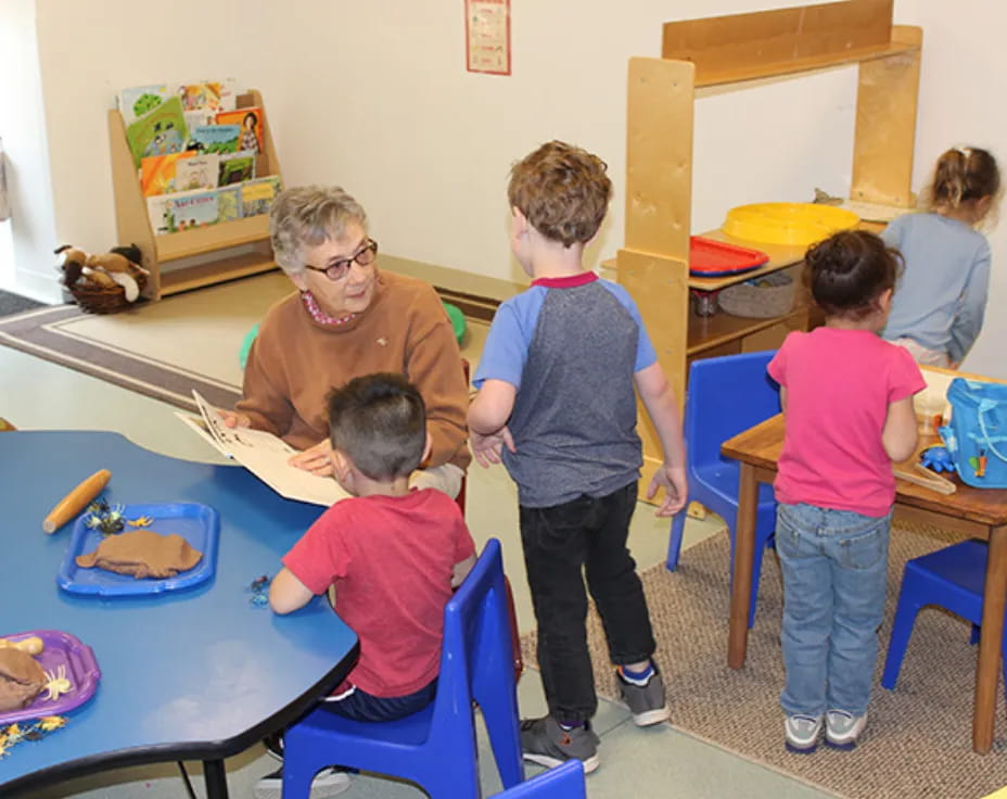 a person and children in a classroom
