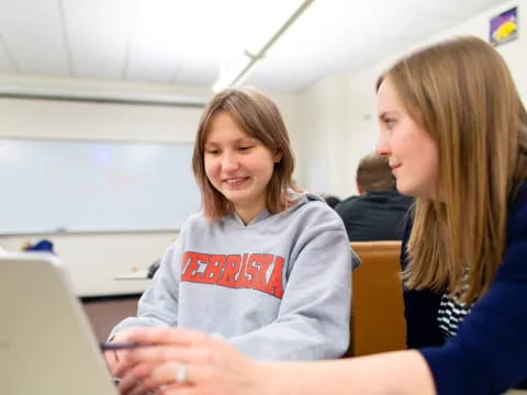 a few women looking at a laptop