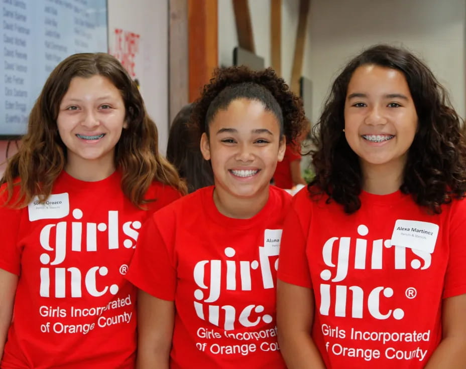 a group of women wearing red shirts