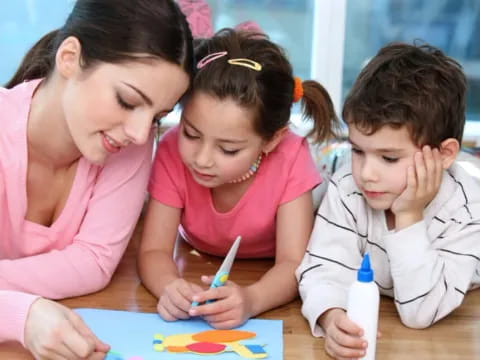 a person and children writing on paper