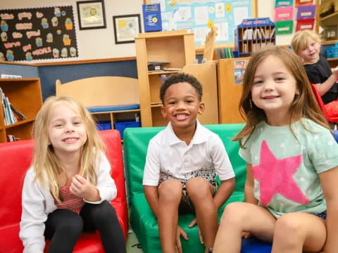 a group of children sitting in chairs