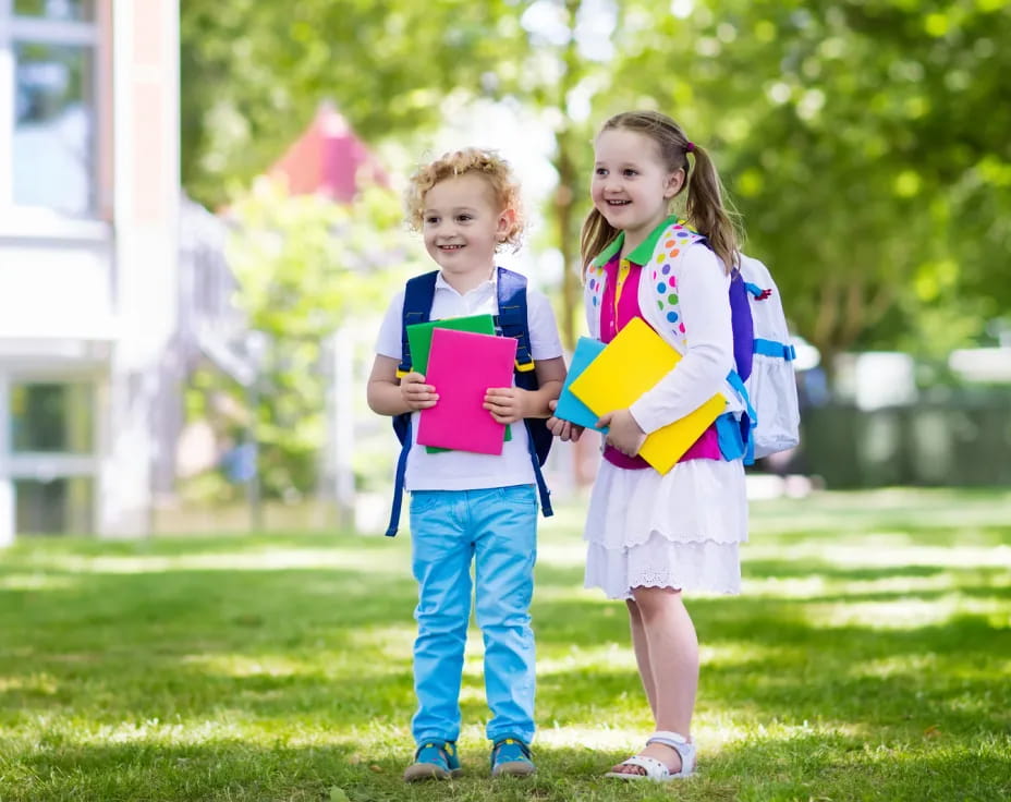 a couple of children holding books