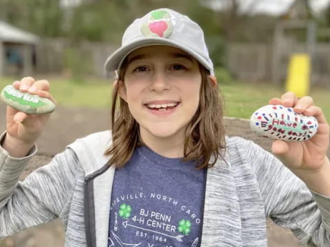 a girl holding a small cupcake