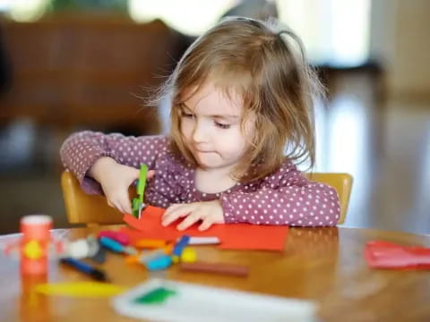 a girl coloring on a paper