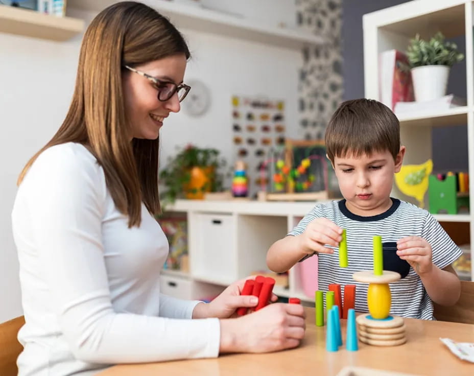 a woman and a boy playing with toys