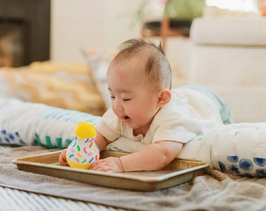 a baby playing with a laptop