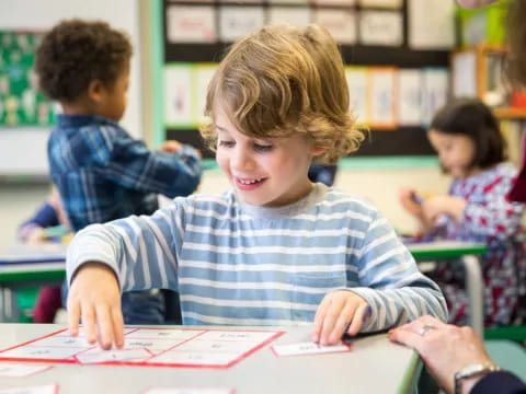 a boy sitting at a desk